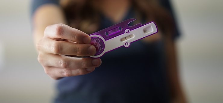 woman holding pregnancy test